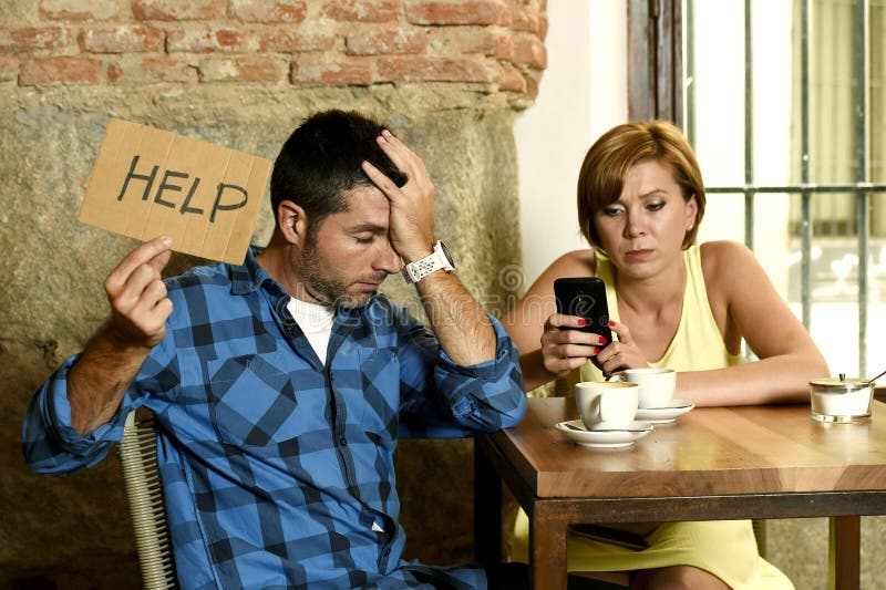 Young American couple at coffee shop with internet and mobile phone addict women ignoring bored sad and frustrated men boyfriend or husband in relationship problem asking for help. Young American couple at coffee shop with internet and mobile phone addict women ignoring bored sad and frustrated men boyfriend or husband in relationship problem asking for help