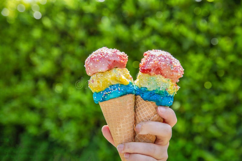 Couple with colorful different flavors of Ice Cream Cone with sprinkles with green leaf background, summer, spring,food