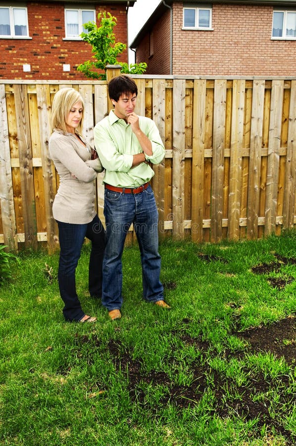 Couple concerned about lawn royalty free stock photo Couple concerned about lawn royalty free stock photo