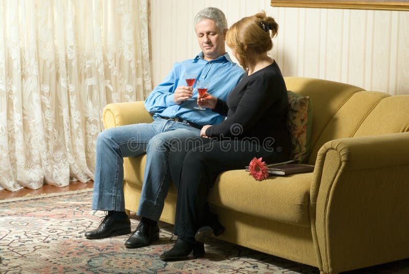 Couple on Couch With Drinks - horizontal