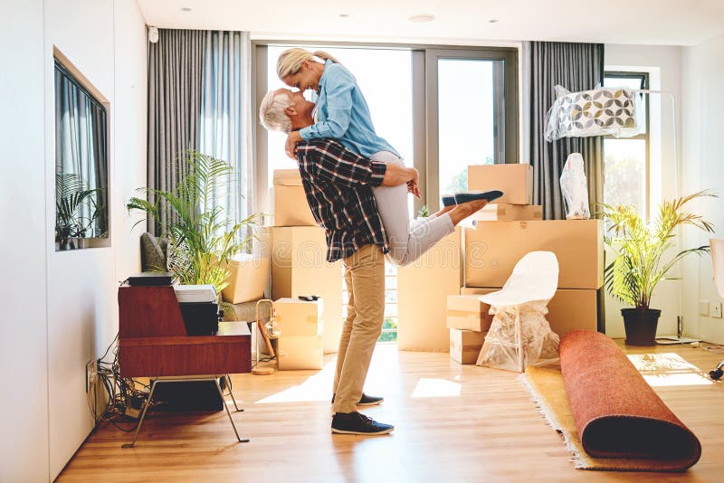 Couple, dance and celebrate in new house or apartment for real estate, property and mortgage or bond success. Mature royalty free stock photos