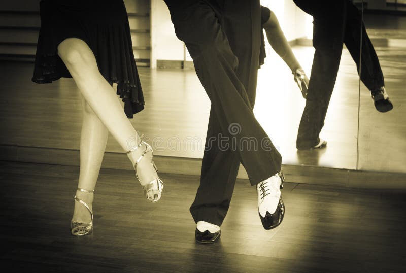 Male and female legs dancing latin rhythms and swing