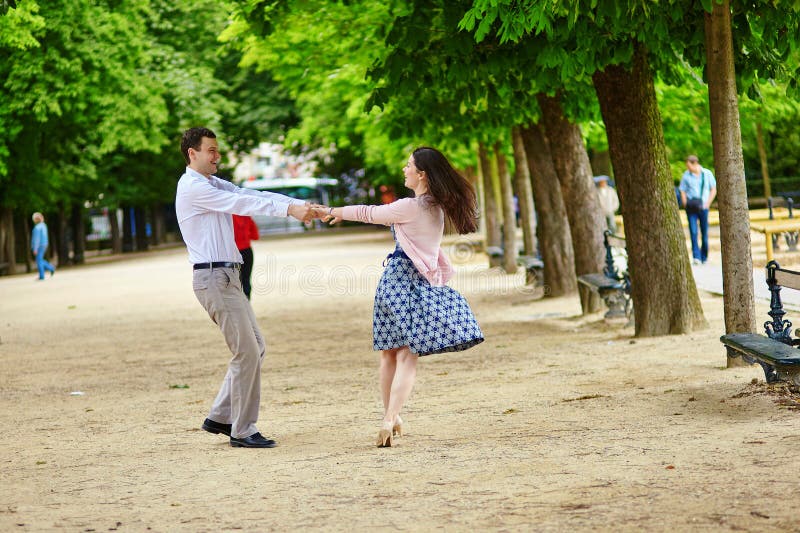 Dating romantic couple dancing in the Luxembourg garden of Paris royalty fr...