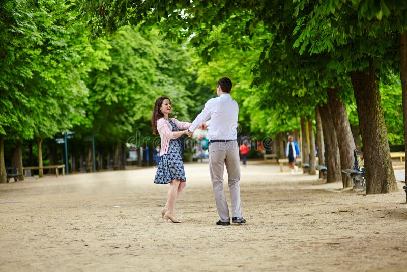 Dating romantic couple dancing in the Luxembourg garden of Paris stock phot...