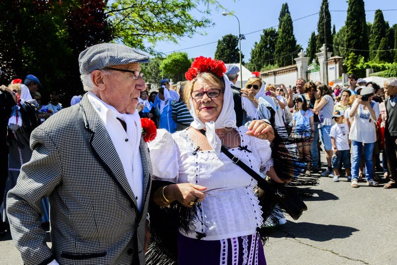 A couple Madrileños dressed in the traditional costume of chulapos, male, and chulapas, female, during the feast of the patron saint of Madrid, San Isidro, in May. A couple Madrileños dressed in the traditional costume of chulapos, male, and chulapas, female, during the feast of the patron saint of Madrid, San Isidro, in May.