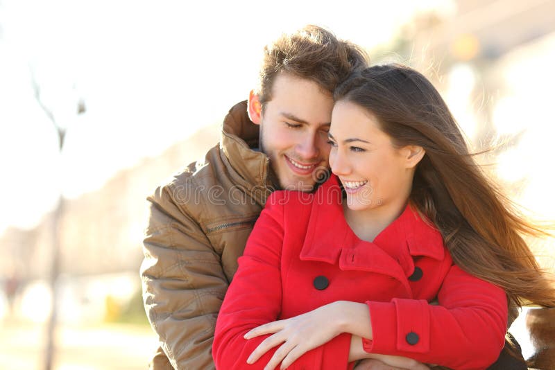 Couple dating and hugging in love in an urban park in a sunny day. Couple dating and hugging in love in an urban park in a sunny day