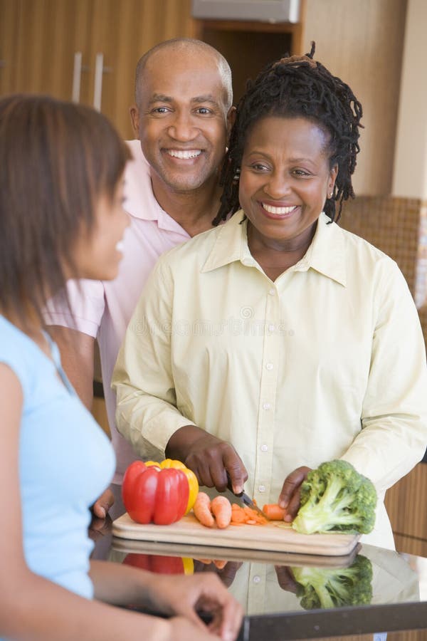 Couple With Daughter Preparing Meal royalty free stock image Couple With Daughter Preparing Meal royalty free stock image