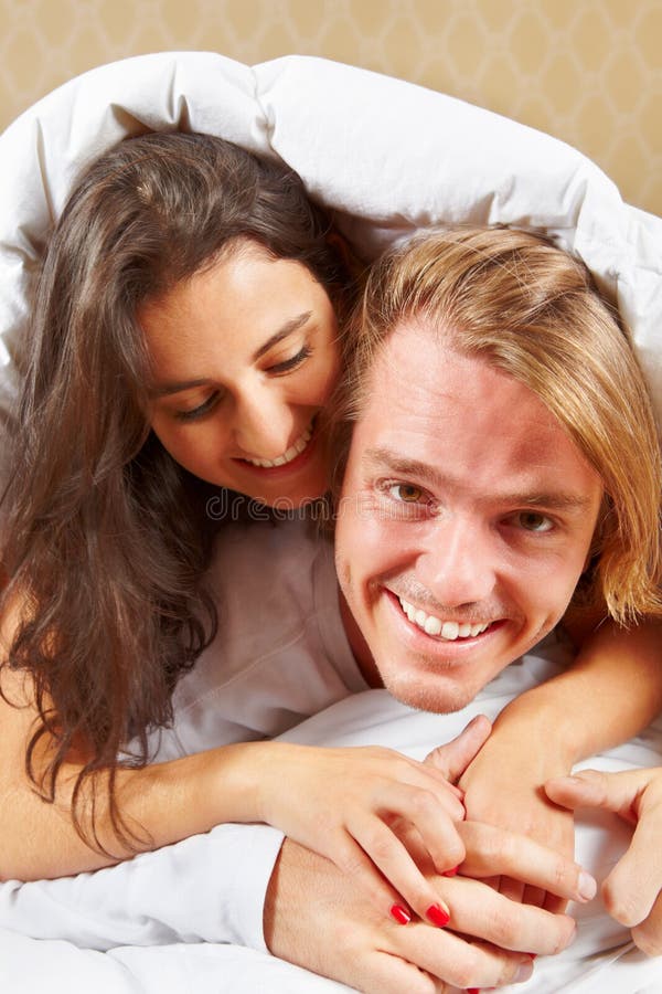 Caring husband embraces wife with love, have glad expressions, holds paper  documents, discuss banking procedures, study bills, drink tea or coffee,  pose indoor, enjoy calm domestic atmosphere 9008724 Stock Photo at Vecteezy