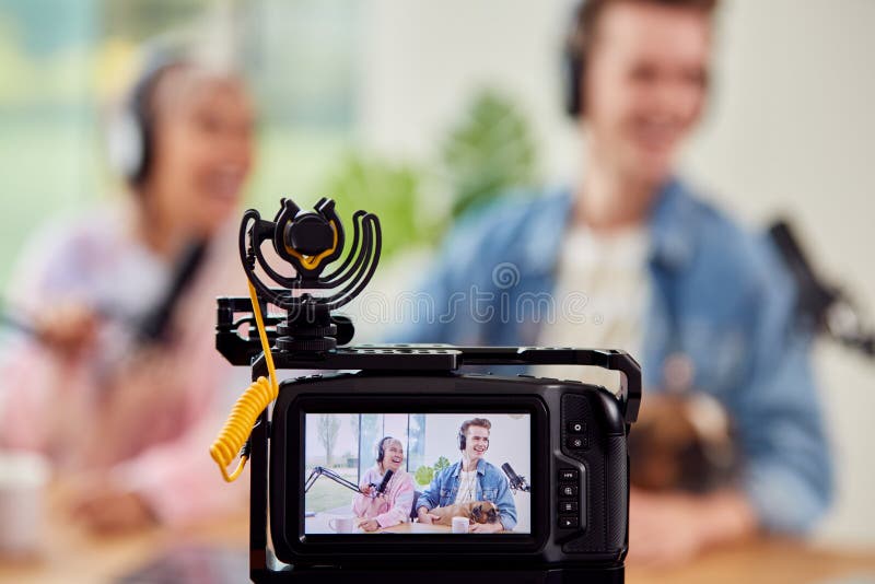 Couple with Dog Vlogging Recording Video at Home with Camera Stock