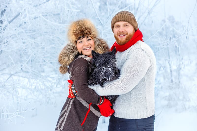 Couple with a dog in winter royalty free stock photo Couple with a dog in winter royalty free stock photo
