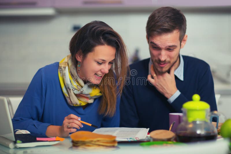 Couple doing documentation for home budgeting at home in th