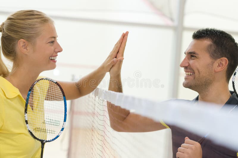 Couple doing high five after badminton match.