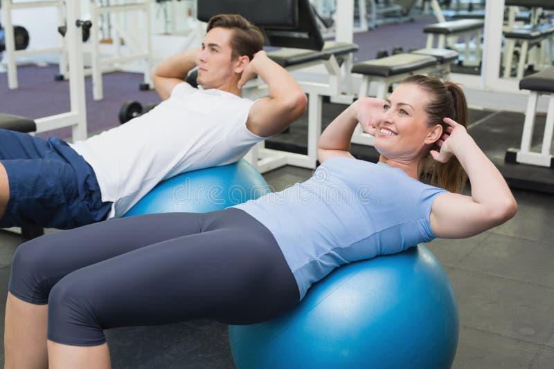 Couple Doing Sit Ups on Exercise Balls Stock Photo Image of caucasian