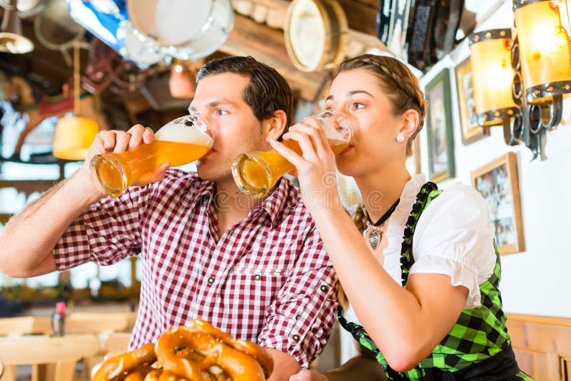 Couple drinking beer in bavarian restaurant