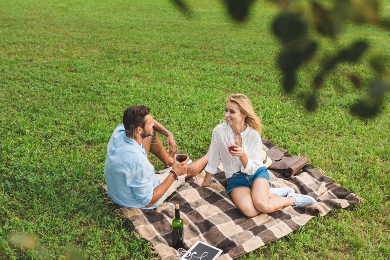 Young Couple Resting on Blanket and Drinking Wine on Romantic Date