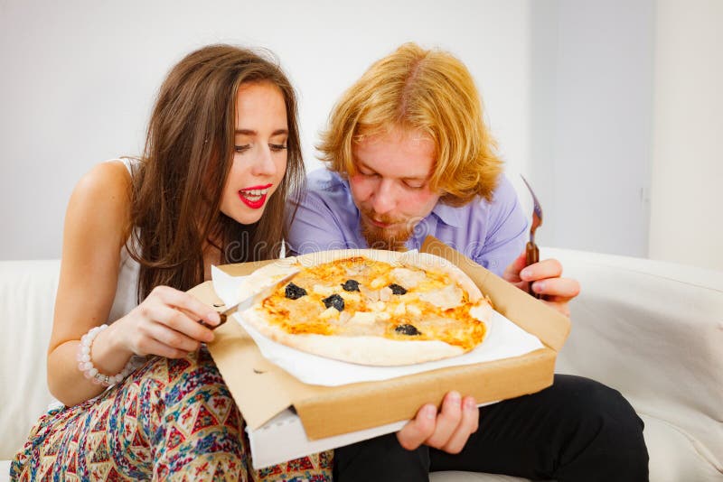 Couple eating pizza stock photo