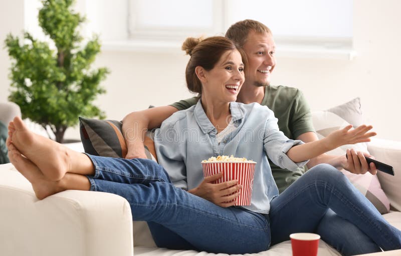 Couple Eating Popcorn while Watching TV at Home Stock Photo Image of