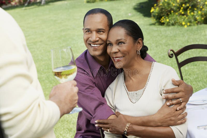 Couple Embracing In Front Of Friend