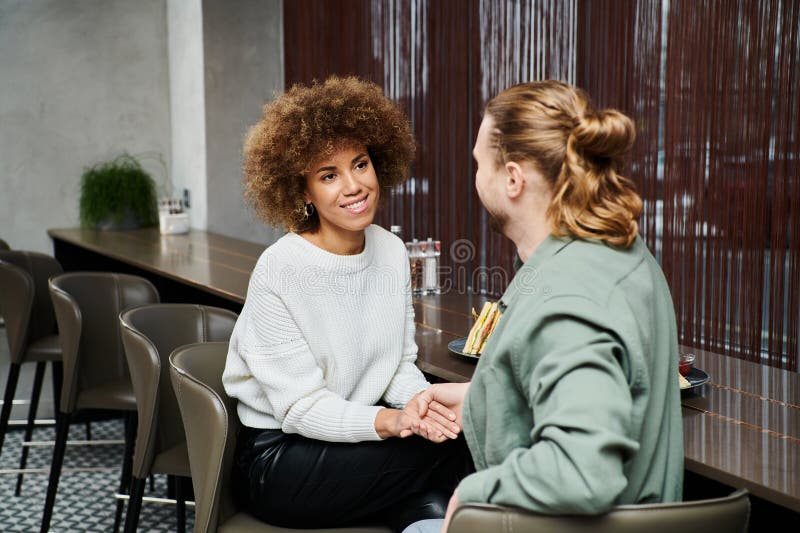 couple engaged in lively discussion at a cozy table in a modern cafe, sharing stories and laughter., stock photo. couple engaged in lively discussion at a cozy table in a modern cafe, sharing stories and laughter., stock photo