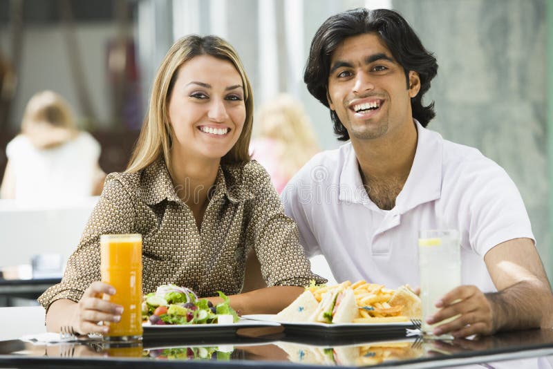 Couple enjoying meal at cafe stock image