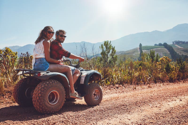 Couple enjoying a quad bike ride in countryside royalty free stock photos Couple enjoying a quad bike ride in countryside royalty free stock photos
