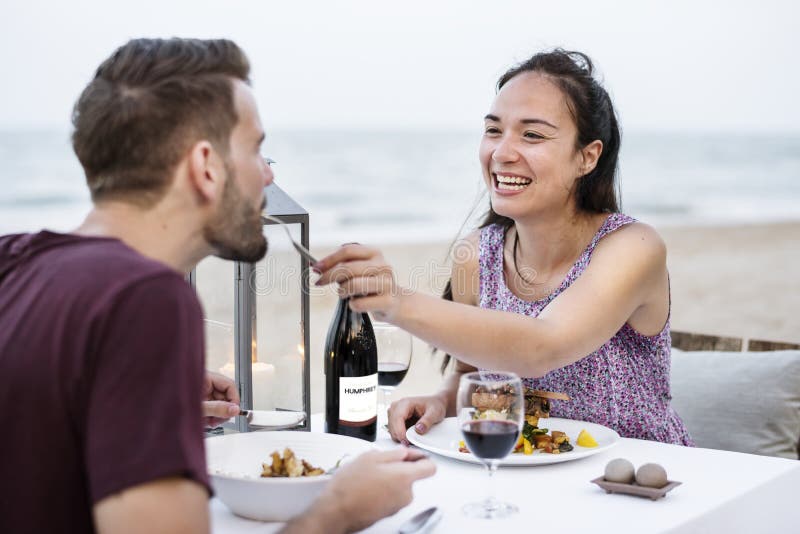 Couple enjoying a romantic dinner at the beach stock photos