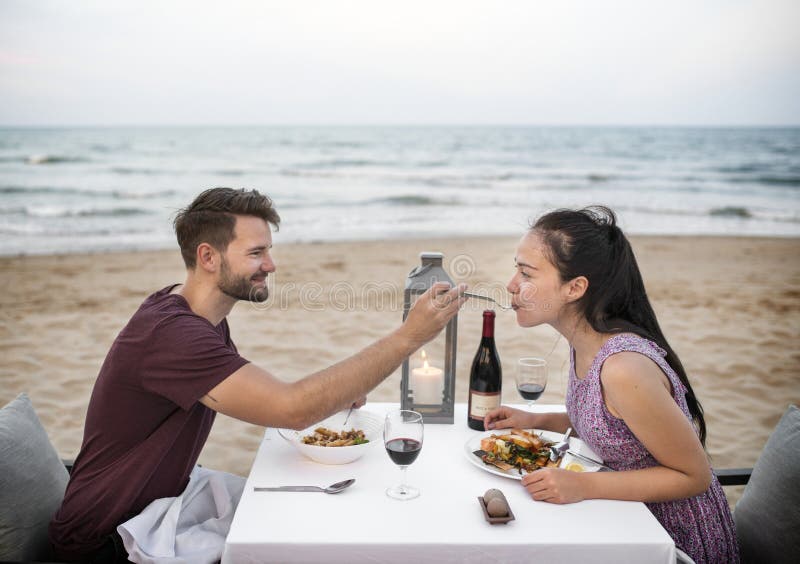 Couple enjoying a romantic dinner at the beach stock photos