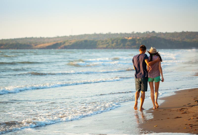 Couple enjoying a romantic evening on the beach at sunset