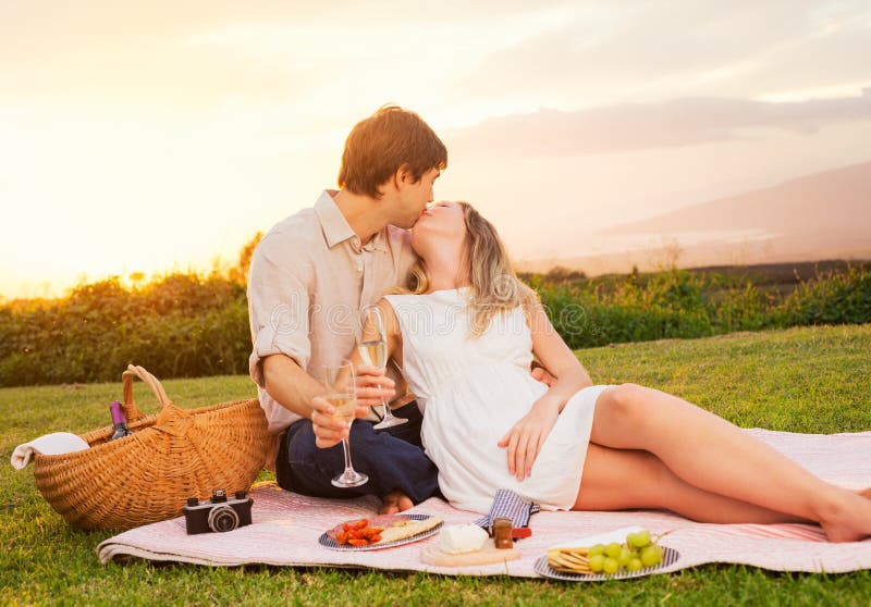 Couple Enjoying Romantic Sunset Picnic Stock Photo - Image of meadow ...