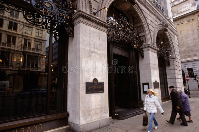 A couple entering an upscale restaurant, London royalty free stock photo