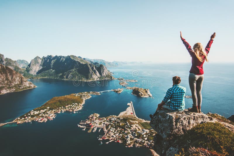 Couple family traveling together on cliff edge in Norway stock photography Couple family traveling together on cliff edge in Norway stock photography