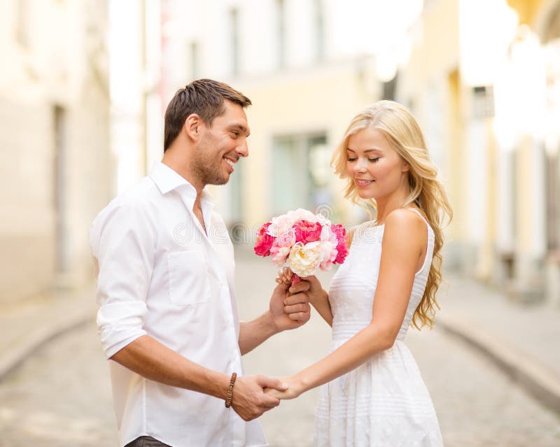 Couple with Flowers in the City Stock Photo - Image of engagement ...