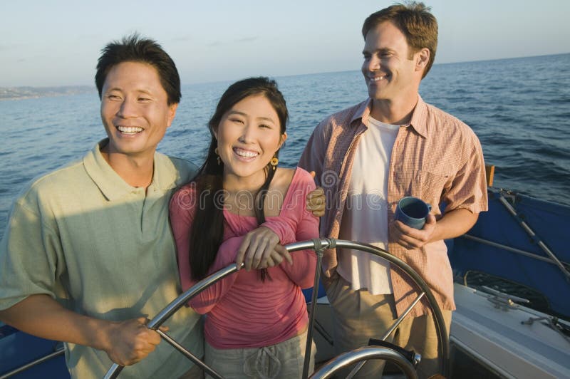 Couple with friend on yacht