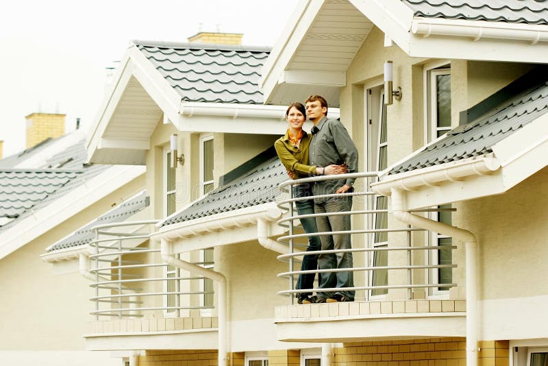 Couple in front of family house stock photography Couple in front of family house stock photography
