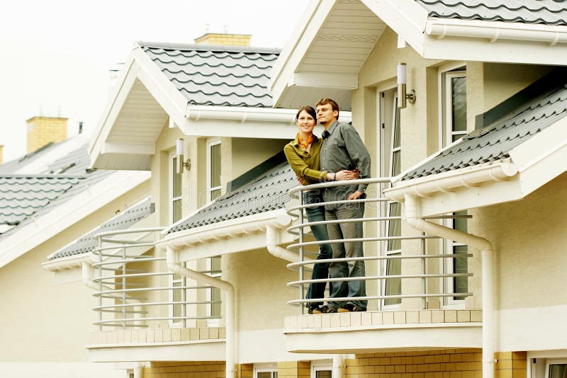 Couple in front of family house