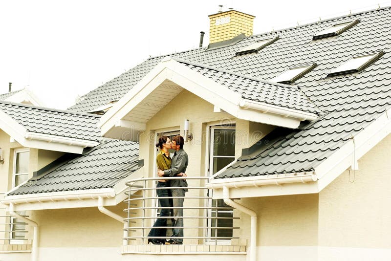 Couple in front of family house in modern residential area