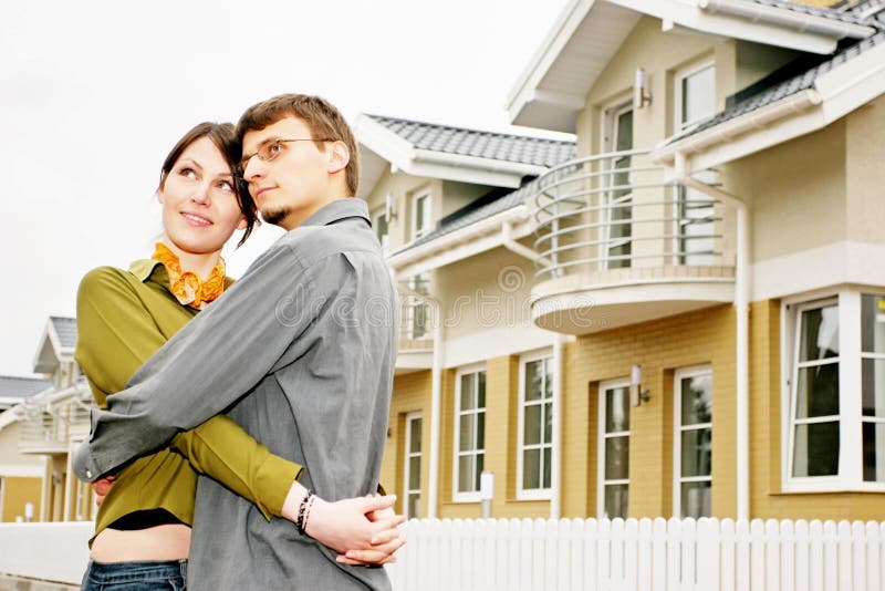 Couple in front of family house in modern residential area