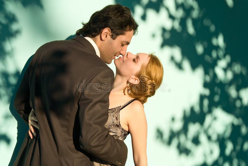 The couple in front of a green background