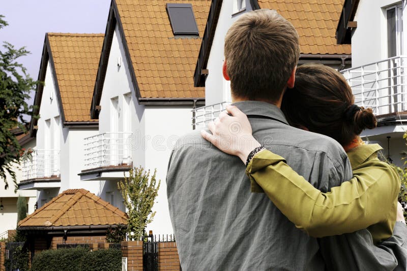 Couple in front of house