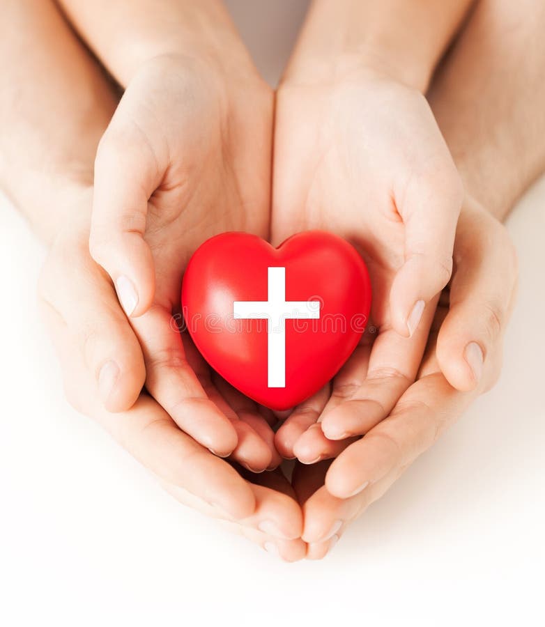 Couple hands holding heart with cross symbol