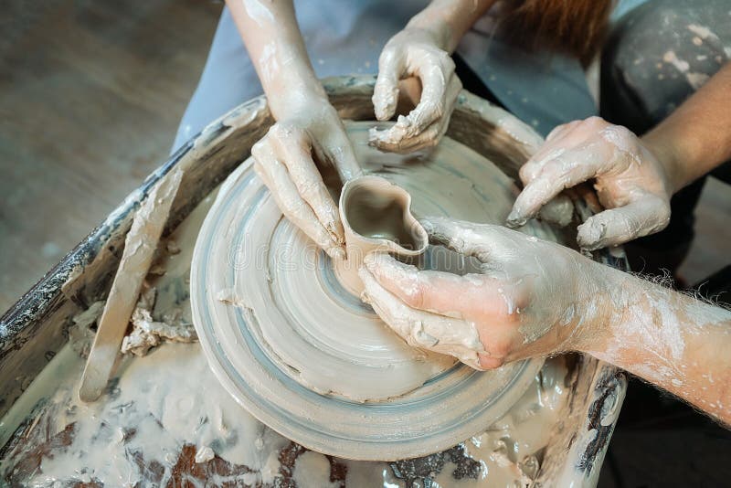 Couple Hands Making Ceramic Cup. Date at the Pottery Closeup