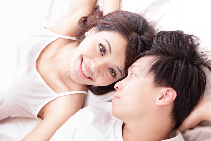 Couple happy smile looking to each other in bed