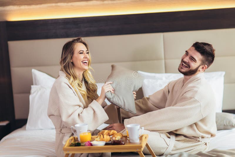 Couple Having Pillow Fight In Hotel Room Stock Photo Image Of Holiday