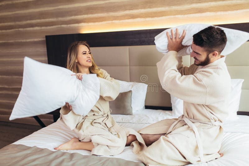 Couple Having Pillow Fight In Hotel Room Stock Image Image Of