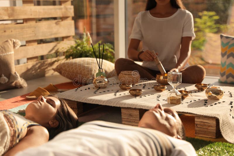 Couple at Healing Session with Singing Bowl Indoors Stock Photo Image
