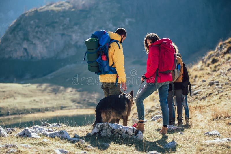 Hikers walking on a mountain at autumn day royalty free stock photos