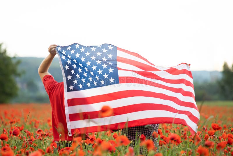 Couple holding the american flag on the 4th of July