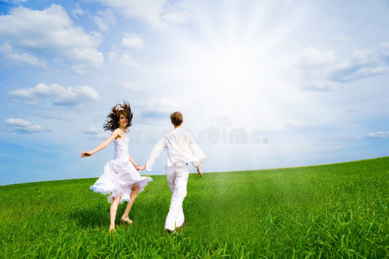 Couple holding hands in a field