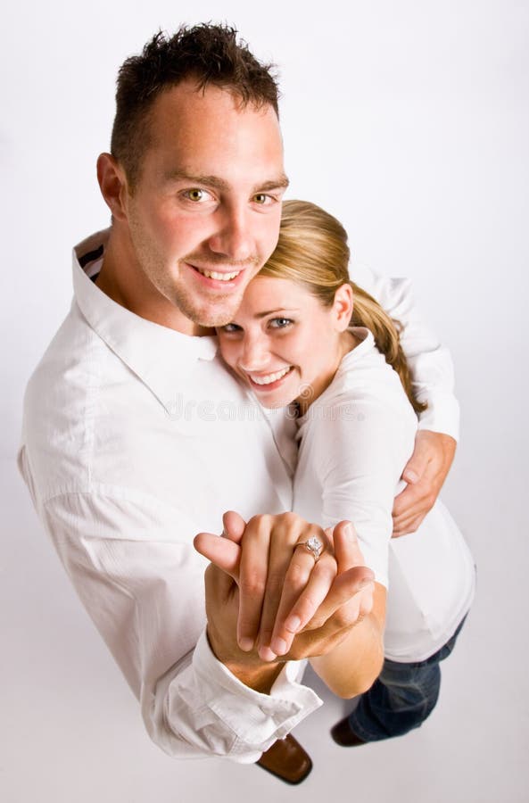 Couple hugging and displaying engagement ring royalty free stock image Couple hugging and displaying engagement ring royalty free stock image