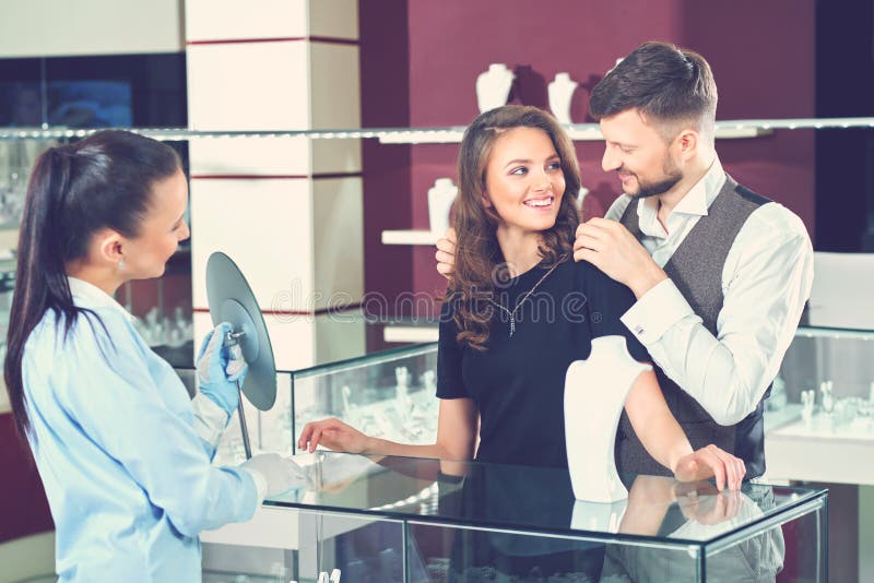 Man Trying Necklace for His Wife at Jewelry Store. Stock Image - Image ...